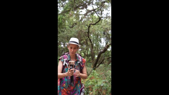 Woman explaining smartphone outdoors
