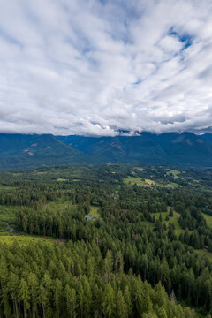 Aerial View of Fraser Valley Forests and Mountains Under Dramatic Cloudscape Near Chilliwack, British Columbia