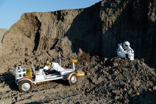 Exploration on the moon with a rover and astronaut in a lunar landscape