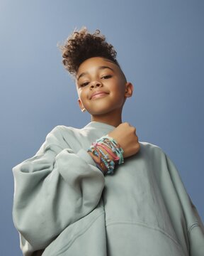 Boy with curly hairstyle and bracelets