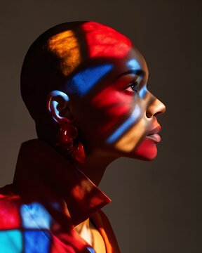 Black woman with colorful light projection on face