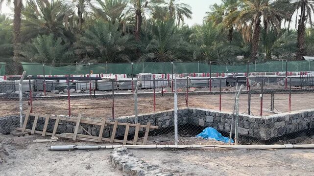Ancient stone ruins being preserved alongside modern construction and excavation work.