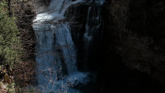Tripod shot of Cueva Waterfall (Cascada de la Cueva) on sunny spring day. Ordesa y Monte Perdido National Park, Spain.