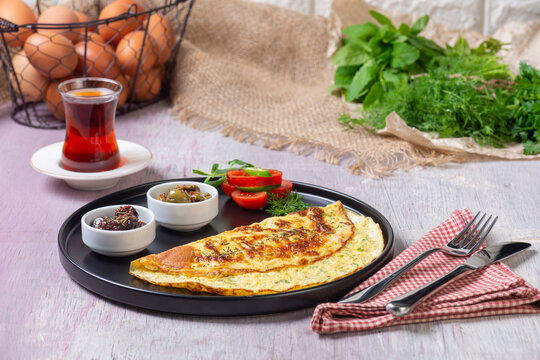 Traditional Turkish Omelet Breakfast Table with Black Tea and Fresh Ingredients