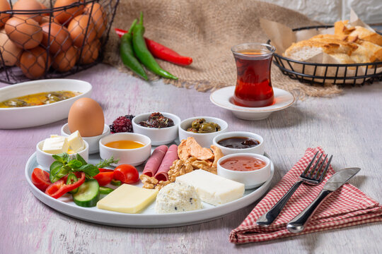 Traditional Turkish Breakfast Platter with Tea, Fresh Bread, and Side Dishes