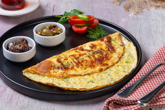 Traditional Turkish Omelet Breakfast Table with Black Tea and Fresh Ingredients