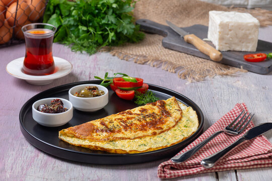 Traditional Turkish Omelet Breakfast Table with Black Tea and Fresh Ingredients