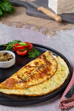 Folded Cheese Omelet with Herbs Served with Olives and Fresh Vegetables