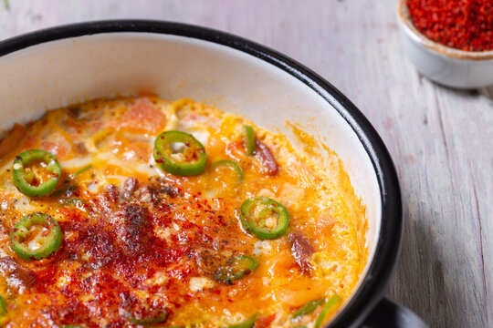 Traditional Turkish Menemen Scrambled Eggs with Tomatoes and Peppers in Enamel Pan