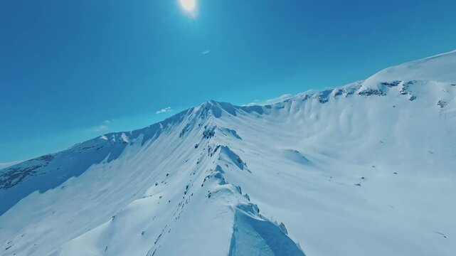 Aerial Fast FPV Drone Flight Along Snowy Mountain Ridge on Windy Day