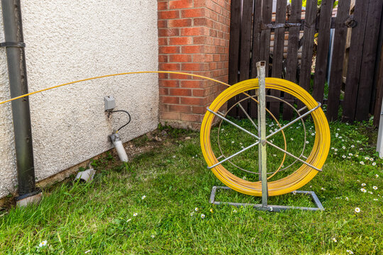 Fibre duct rod reel on stand during FTTP broadband installation