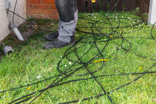 Fibre and copper cables spread on lawn after successful duct pull-through