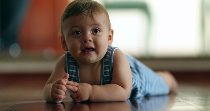 Cute baby boy smiling to camera crawling at home