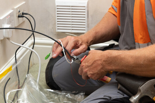 Telecoms engineer terminating fibre optic cable with SC APC connector for FTTP install