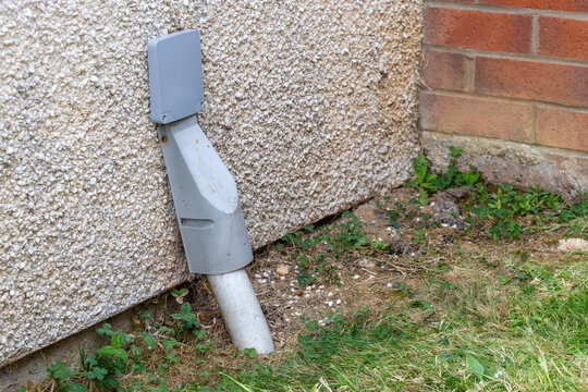 Completed fibre entry bracket with trunking on pebbledash exterior wall after FTTP installation