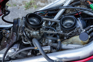 Fototapeta premium Twin motorcycle carburetors mounted on a vintage engine