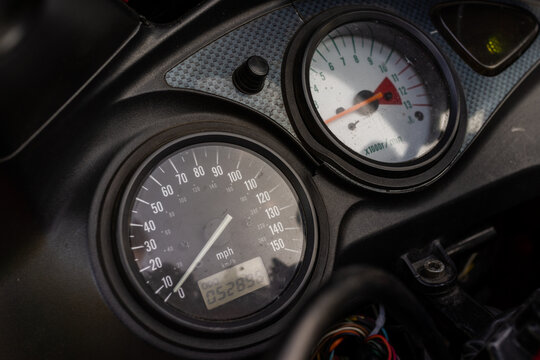 Motorcycle speedometer and tachometer dashboard in close up