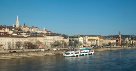Fototapeta premium Panoramic view of Buda hill with Matthias Church and cruise boat on Danube river, Budapest, Hungar