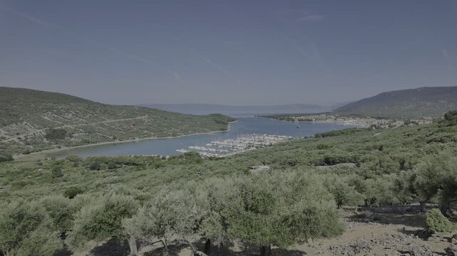 TIME-LAPSE: Cres town overlooking Kvarner Gulf on Croatia's Cres Island. Featuring a vibrant harbor with numerous boats and historic Venetian-style buildings under summer sky of Cres Island in Croatia