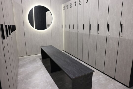 Bench, lockers and mirror in gym changing room