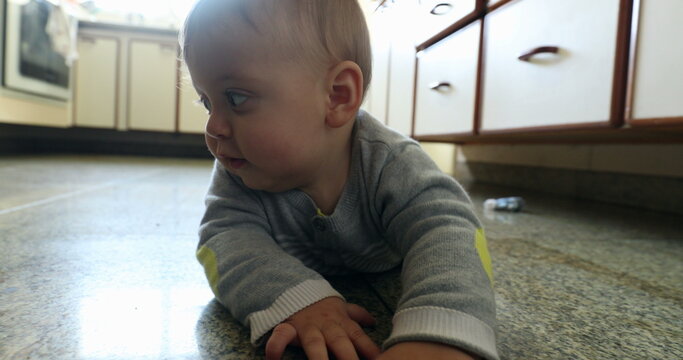 Casual authentic baby home scene at kitchen floor