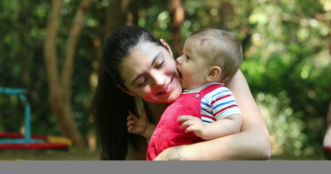 Casual interaction between mother and baby infant son relationship outside smiling and happy