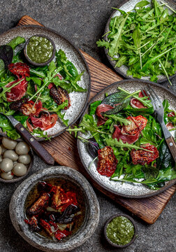 Salad with arugula, spinach, dried tomato and ham serrano paleta iberica. Low carbs keto recipe