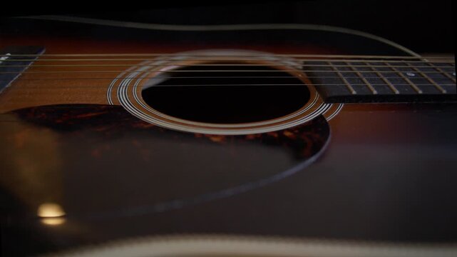 Low Angle View of Acoustic Guitar Sound Hole During Cleaning Shot with Cinema Camera