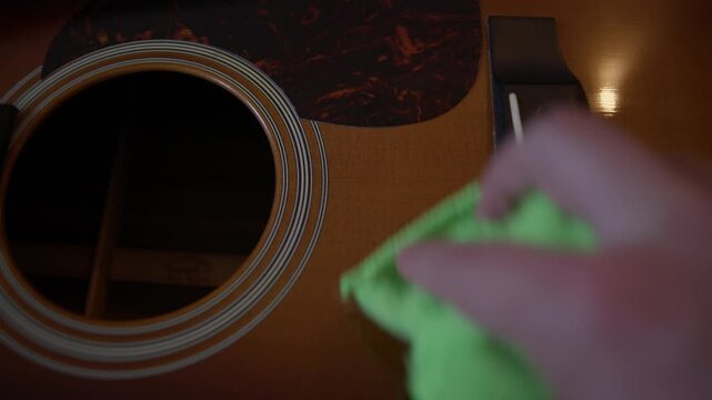 Wiping Acoustic Guitar Fretboard Before Restringing Close Up Shot with Cinema Camera