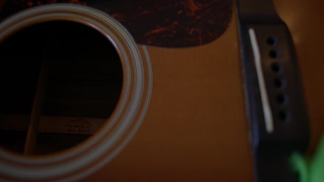 Cleaning Acoustic Guitar Fretboard with Microfiber Cloth During Maintenance Shot with Cinema Camera