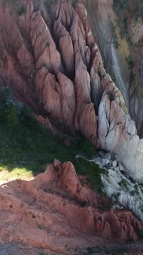 High angle drone shot of sharp limestone spires and dramatic clay ravines in Kazakhstan
