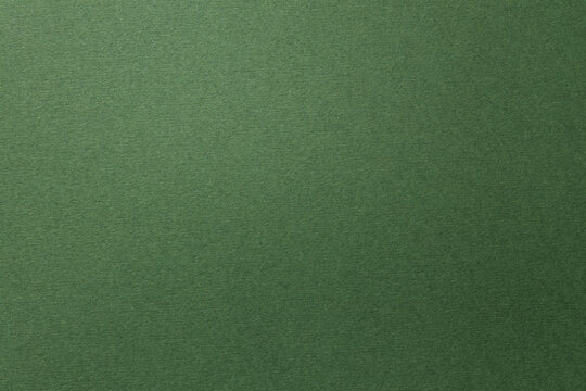 Textured dark green paper background with copy space for design projects