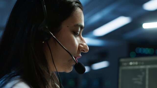 In a server room, iT expert provides technical support with a microphone, supporting performance oversight, system reliability and technical support during hardware and software coordination