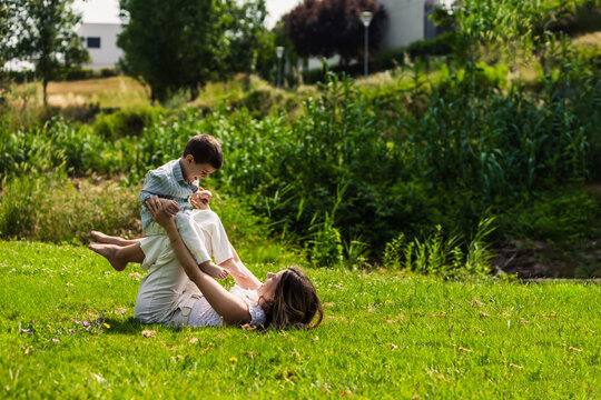 Mother and child playing, balancing on legs, enjoying time