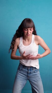 Energetic young woman dancing and smiling