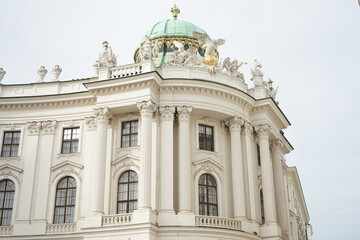 Fototapeta premium Ornate white building with green dome and statues against sky