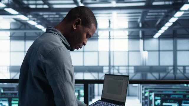 In a server farm, engineers use laptop while handling network architecture, IT team and laptop workflow across infrastructure operations within a controlled technical environment.