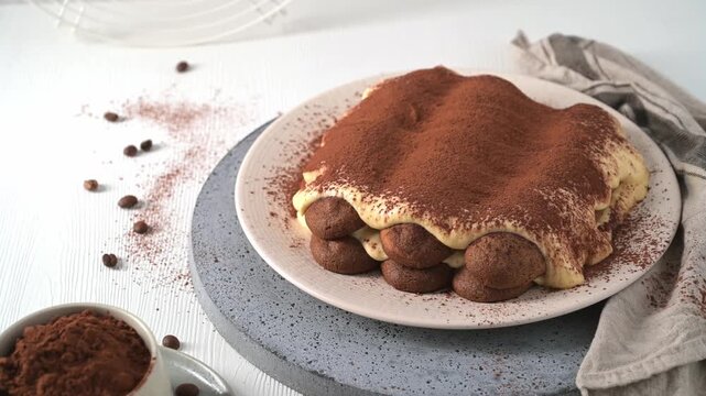 A delicious Italian dessert sits on a textured ceramic plate under soft morning light, garnished with scattered coffee beans and fine cocoa dust.