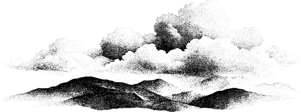 Mountain range with cloud formations over misty horizon
