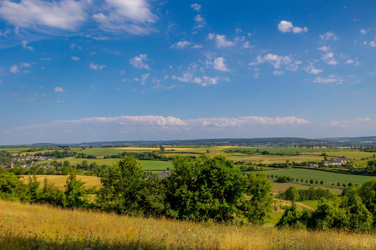 Summer landscape, The terrain of hilly countryside, A hamlet on hillside with green grass meadow and tree, Eys is a village in the municipality of Gulpen-Wittem and region in Zuid-Limburg, Netherlands