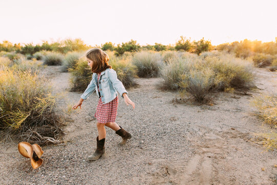 Little Girl Chasing Her Cowboy Hat in the Arizona Desert