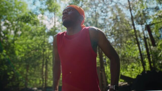 African American young adult man performing dips on parallel bars at outdoor gym in slow motion. Footage is perfect for fitness, wellness, and athletic training campaigns