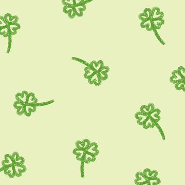 seamless pattern with green clover on a light yellow background