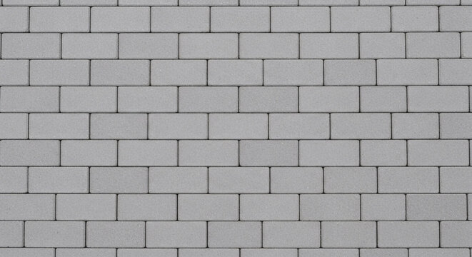 Gray paving stone texture background featuring clean rectangular bricks arranged in a uniform pattern for outdoor architectural design projects