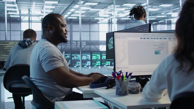 Engineer writing code and performing checkup on server room from a secondary camera angle while highlighting data protection, network security and infrastructure risk.