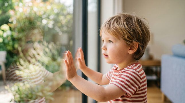 Child Looking Out at Garden with Wonder