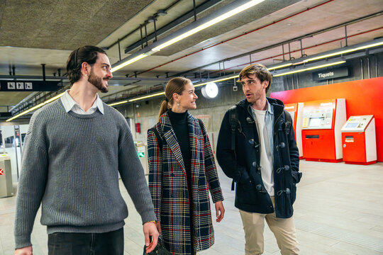 Business coworker chat in city metro station on commute