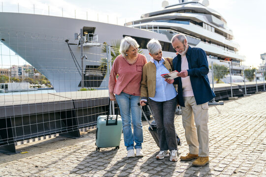 Seniors exploring travel opportunities by the harbor