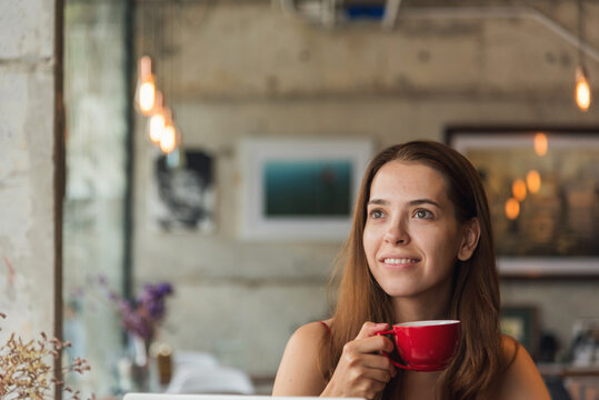 Women lifestyle Cafe. Young woman smile face love drink coffee. Active woman drinking black tea cup in coffee shop holding fresh mug. Asian Woman drink black coffee hand holding cup at cafe garden