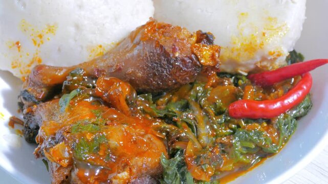 Traditional East African ugali and sukuma wiki with chicken close up